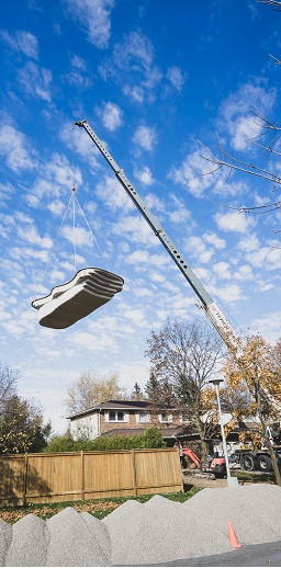 Crane Above Home with Fiberglass Pool